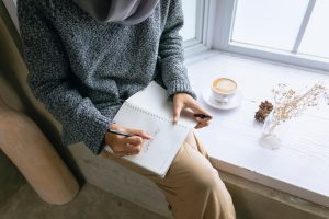 https://pixabay.com//?utm_source=link-attribution&utm_medium=referral&utm_campaign=image&utm_content=6886598 Woman writing 'Stay Healthy' in a journal while having a morning coffee